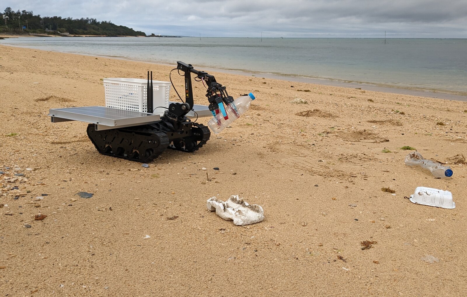 Tracked cleanup robot operating on a beach in Okinawa.